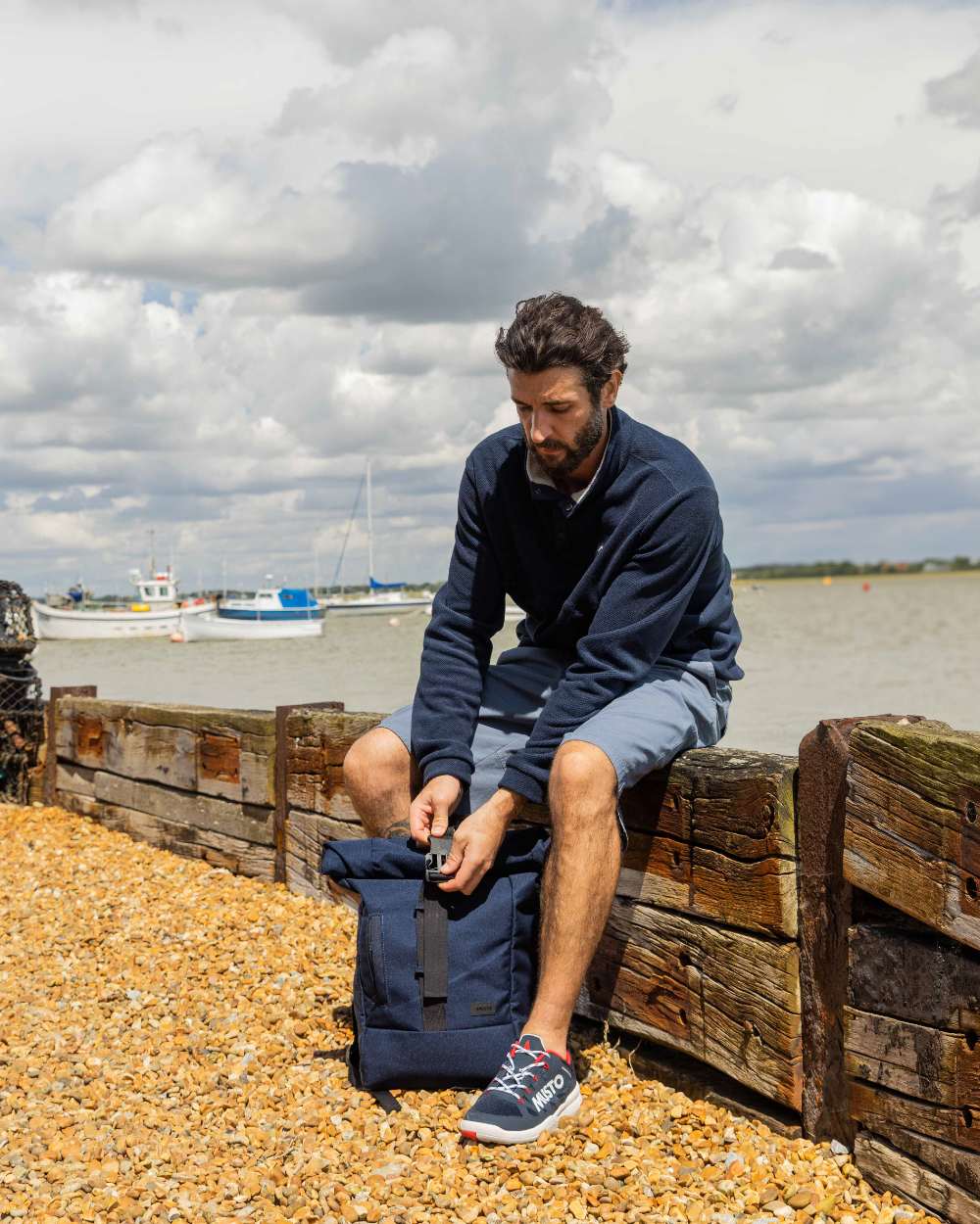 Navy Coloured Musto Mens Classic Fleece Pullover On A Beach Background 