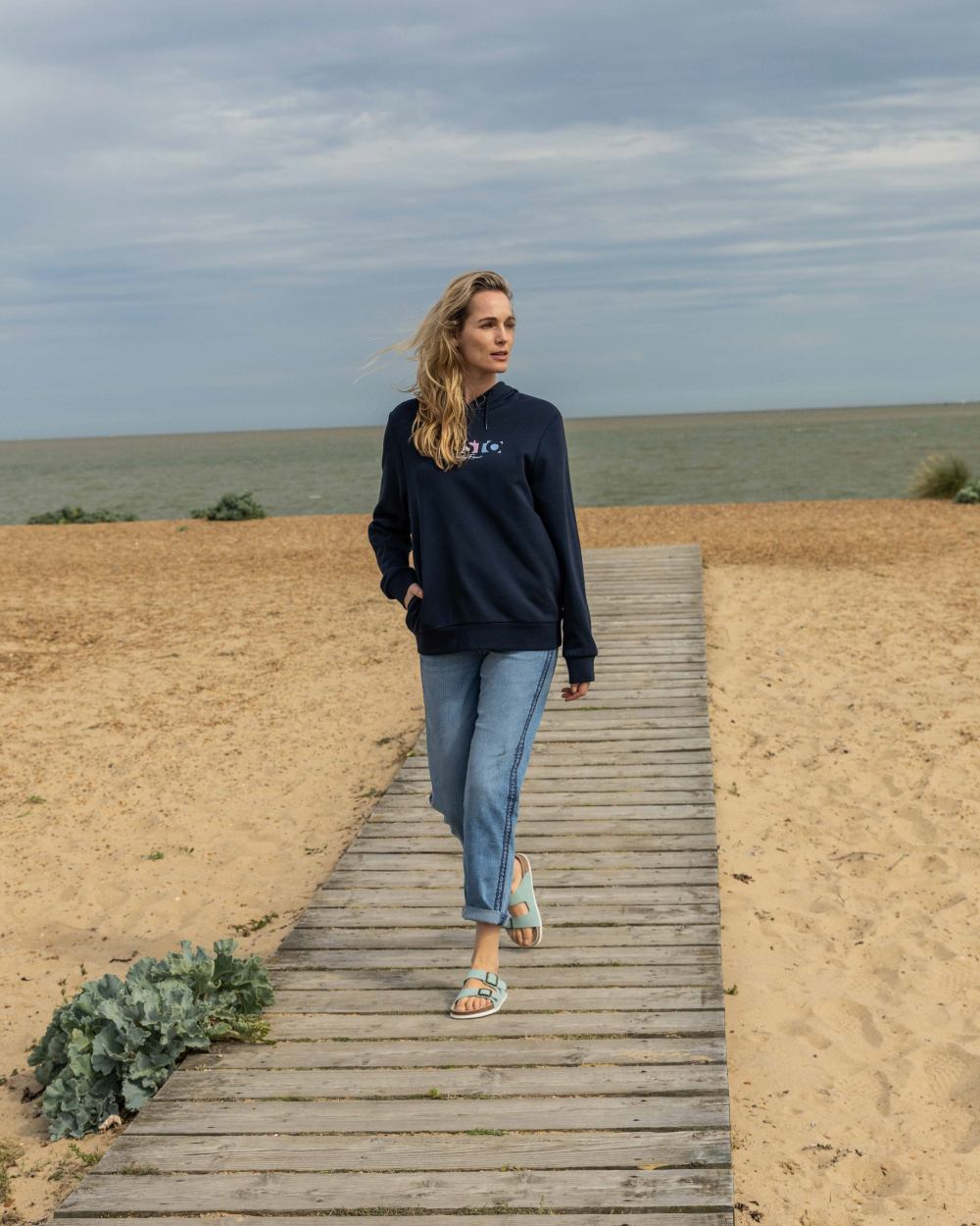 Navy Coloured Musto Womens 1964 Hoodie On A Beach Background 