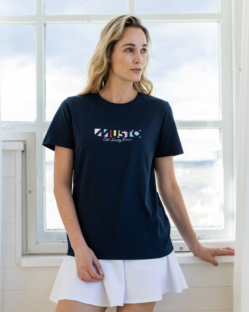 Navy Coloured Musto Womens 1964 Short Sleeve T-Shirt On A Coastal Background 