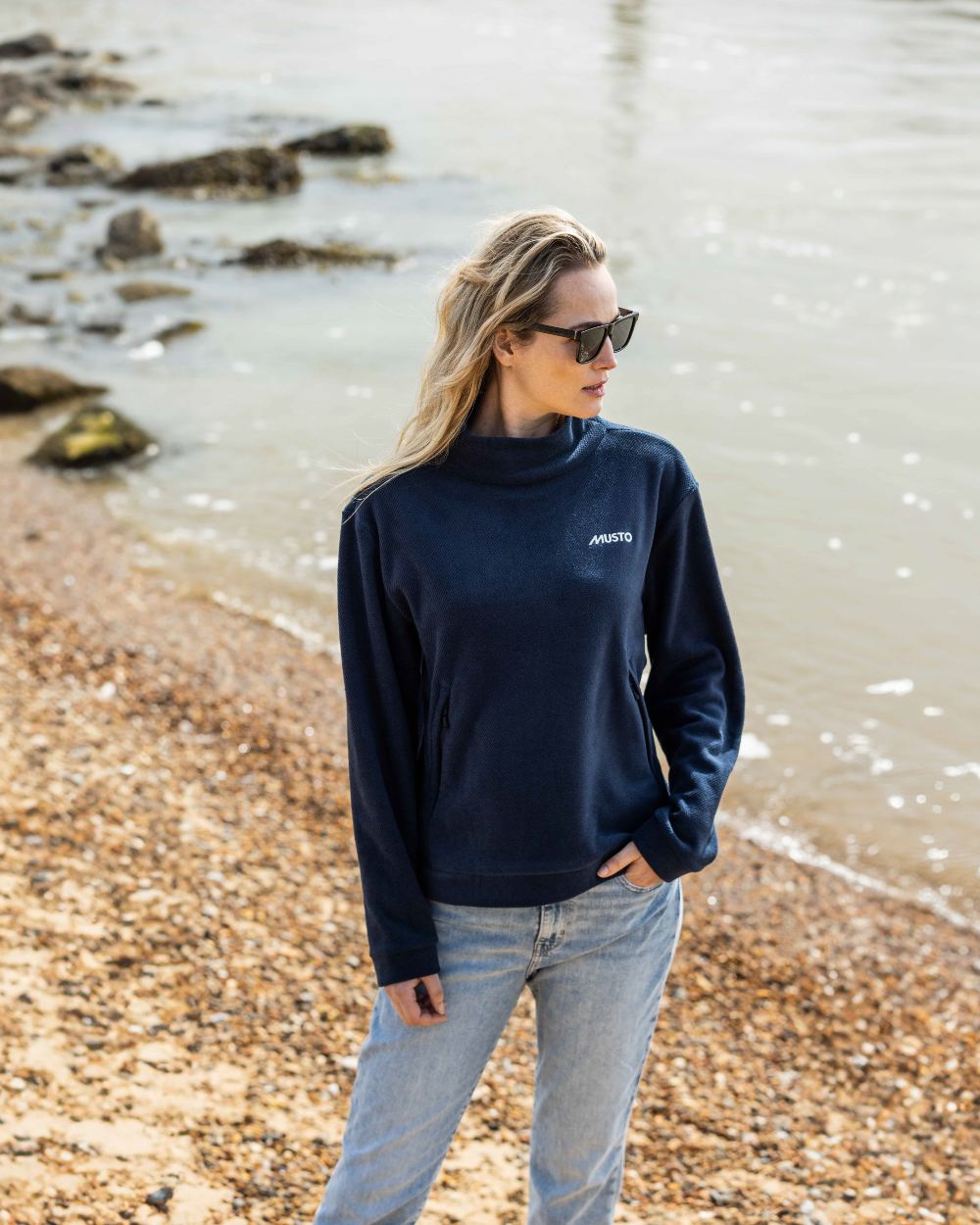 Navy Coloured Musto Womens Classic Fleece Pullover On A Beach Background 