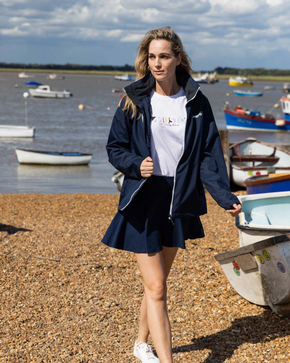 Navy Coloured Musto Womens Nautic Rain Jacket On A Beach Background 