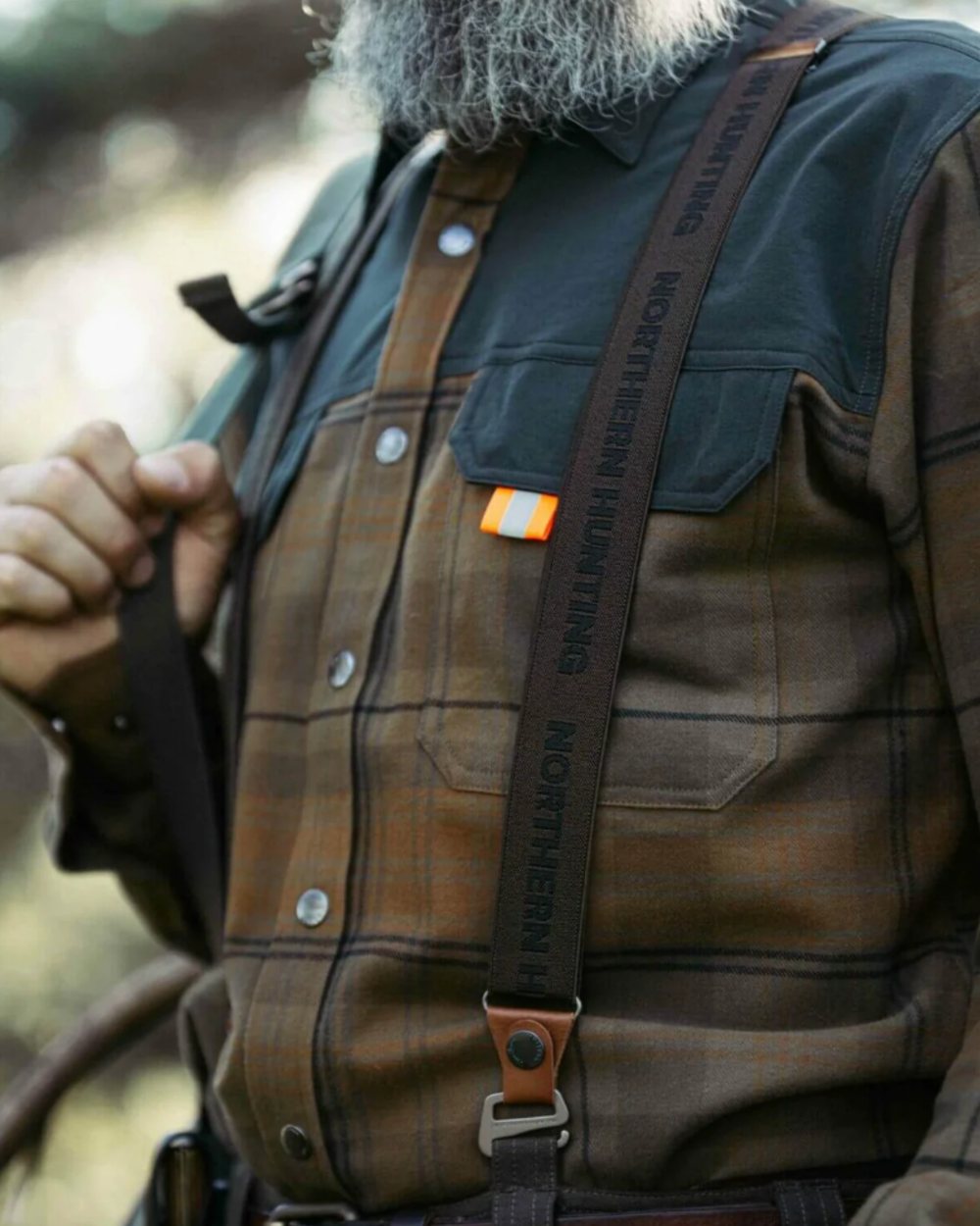 Green coloured Northern Hunting Hjalm Suspenders on forest background 