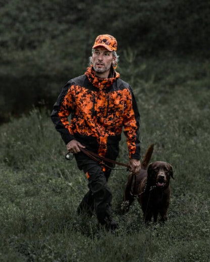 Dark Green Orange Blaze coloured Northern Hunting Mens Falkor Aks Waterproof Hunting Jacket on forest background 