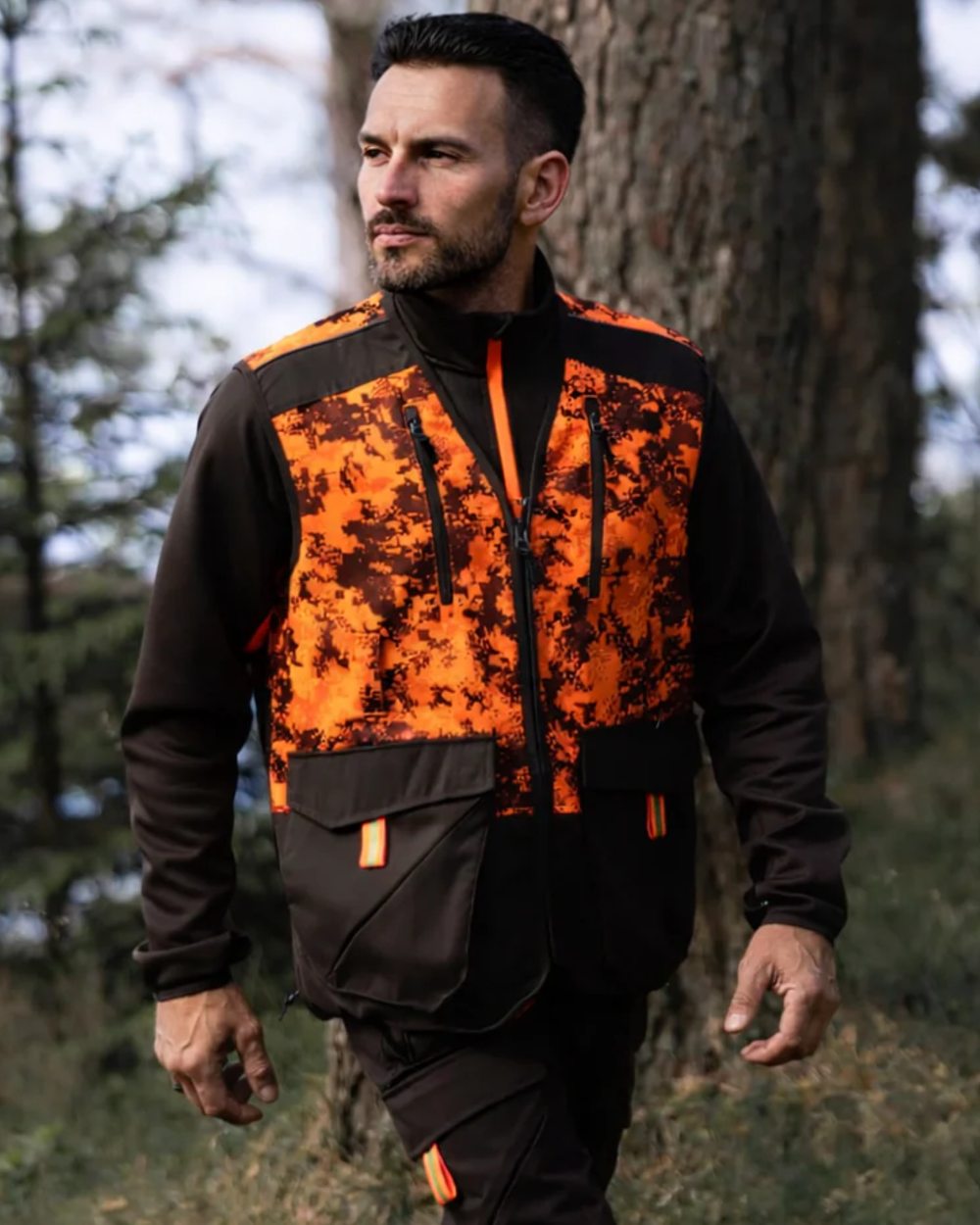 Dark Green Orange Blaze coloured Northern Hunting Mens Falkor Tark Hunting Vest on forest background 