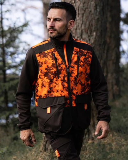 Dark Green Orange Blaze coloured Northern Hunting Mens Falkor Tark Hunting Vest on forest background 