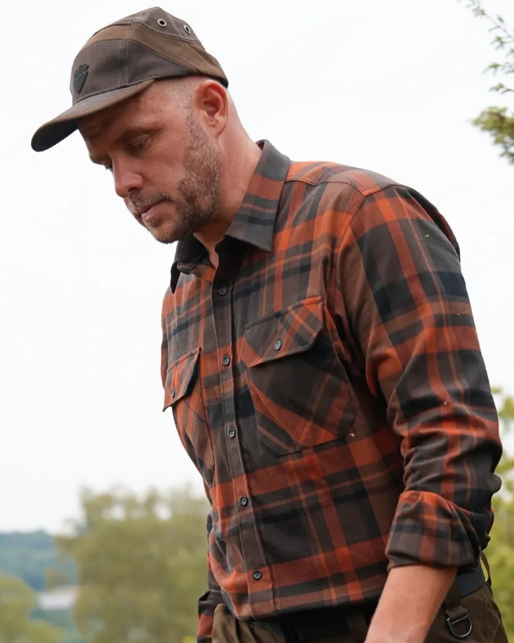 Orange coloured Northern Hunting Mens Fjord Organic Cotton Shirt on outdoor background 