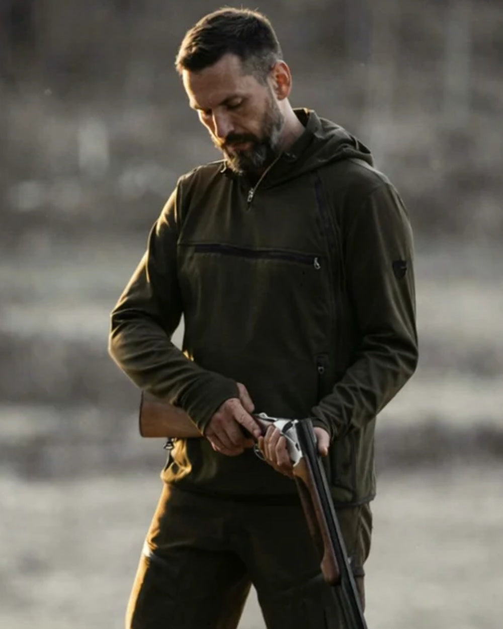 Dark Green coloured Northern Hunting Mens Hagni Shell Jacket on forest background 