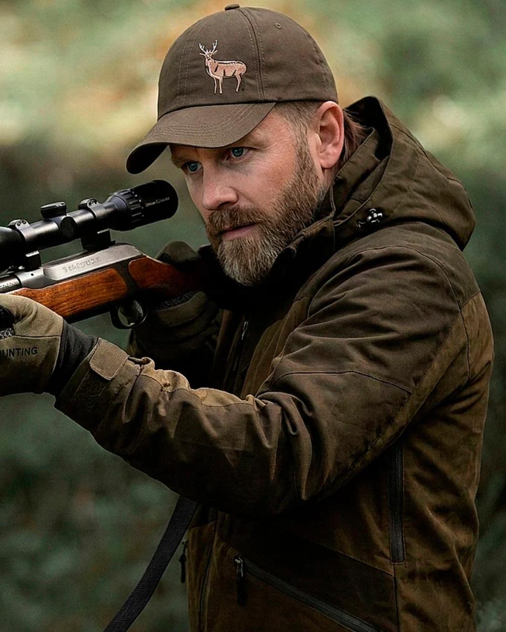 Green coloured Northern Hunting Mens Hakan Elk Waterproof Hunting Jacket on forest background 