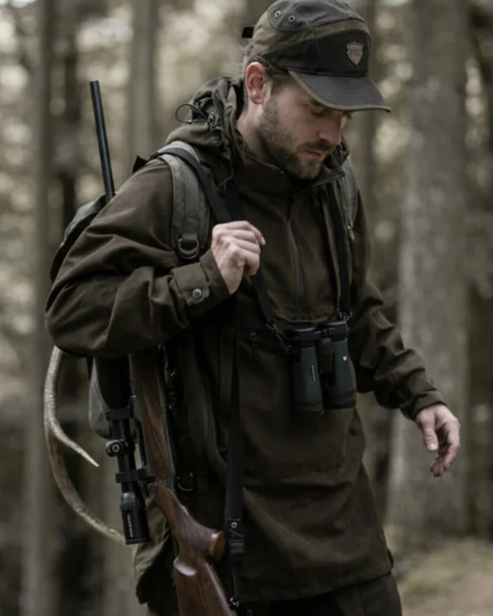 Green coloured Northern Hunting Mens Storr Waterproof Hunting Anorak on forest background 