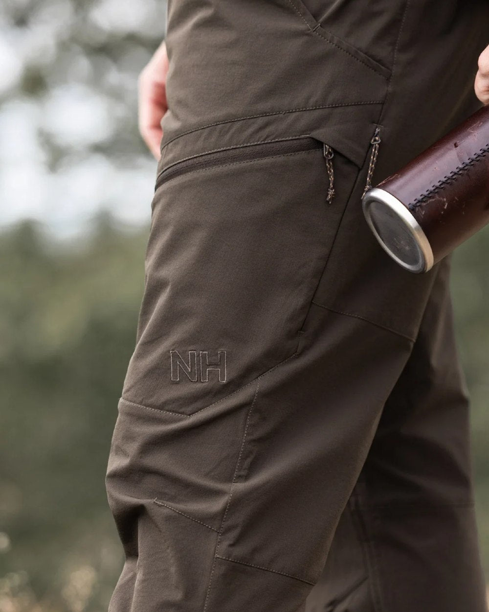 Dark Green coloured Northern Hunting Mens Toke Light Tanatex Outdoor Trousers on forest background 