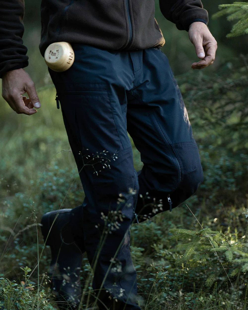 Black coloured Northern Hunting Mens Trond Pro Outdoor Trousers on forest background 