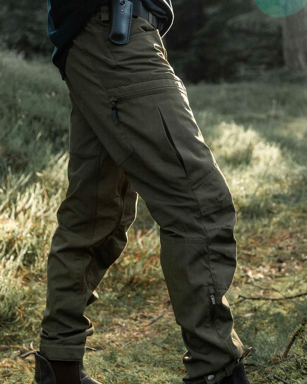 Olive coloured Northern Hunting Mens Trond Pro Outdoor Trousers on forest background 