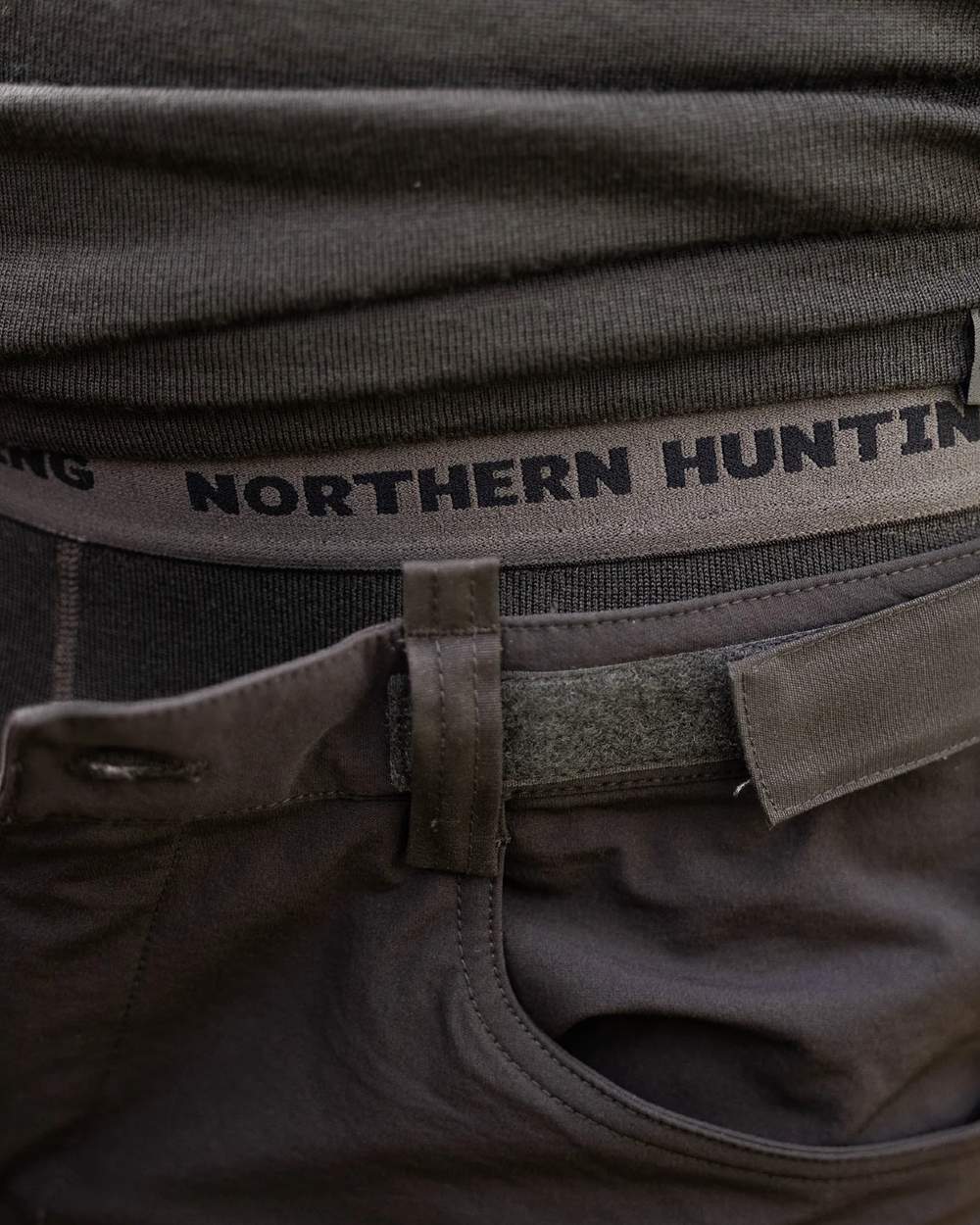 Dark Green coloured Northern Hunting Norr Fal Baselayer Pants on forest background 