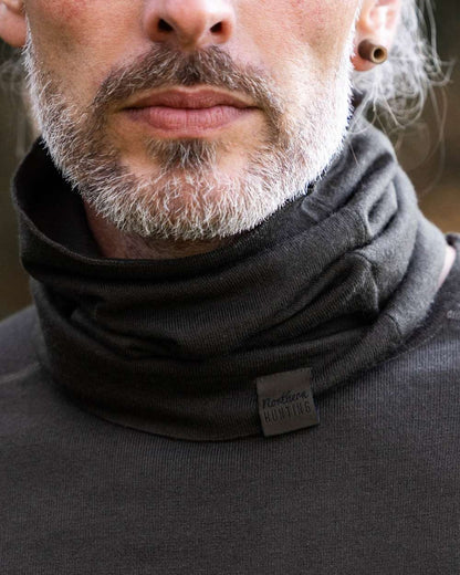 Dark Green coloured Northern Hunting Norr Lark Merino Neck Gaiter  on forest background 