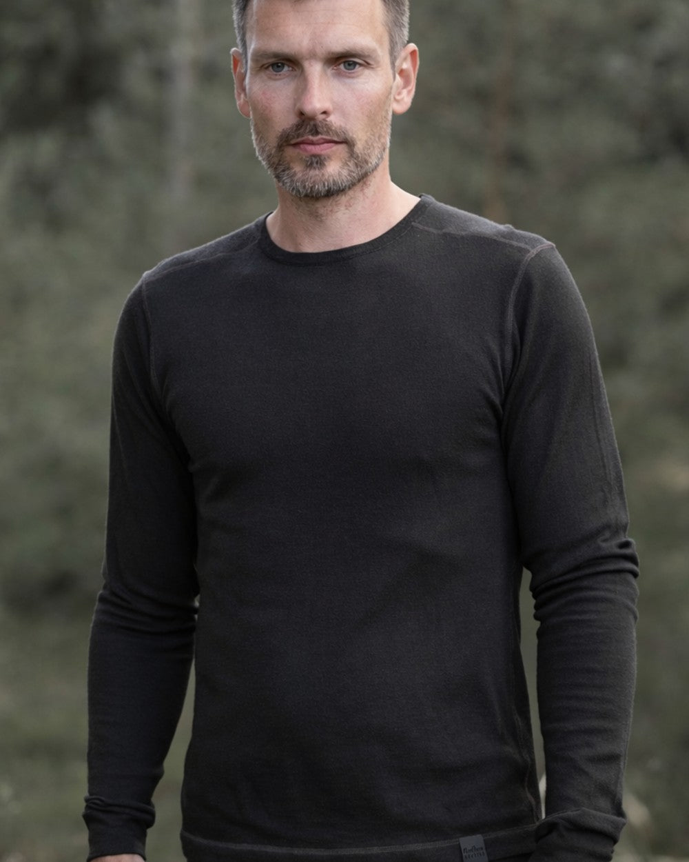 Dark Green coloured Northern Hunting Norr Vik Long Sleeve Baselayer Top on forest background 