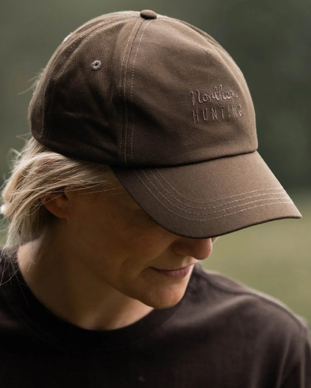 Green coloured Northern Hunting Ravn Water Repellent Cap on blurry background 