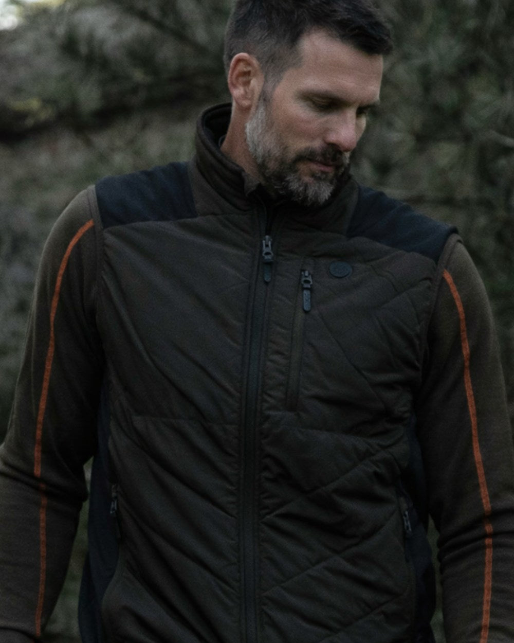 Dark Green coloured Northern Hunting Reidar Heat Vest on forest background 