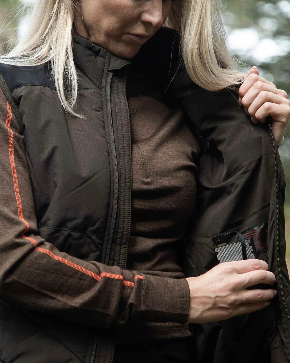 Dark Green coloured Northern Hunting Reidar Heat Vest on forest background 