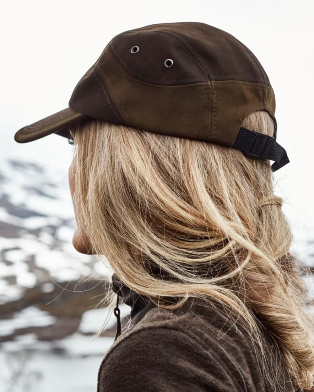 Dark Green coloured Northern Hunting Roald Cap on outdoor background 