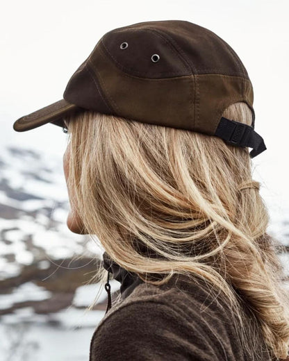 Dark Green coloured Northern Hunting Roald Cap on outdoor background 