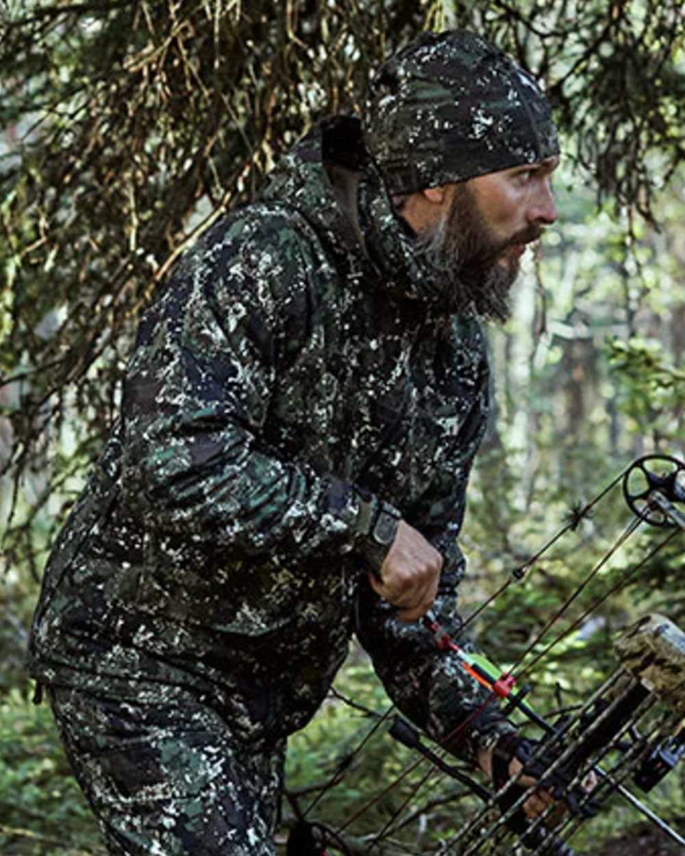 Camo coloured Northern Hunting Trand Stretch Opt2 Beanie on forest background 
