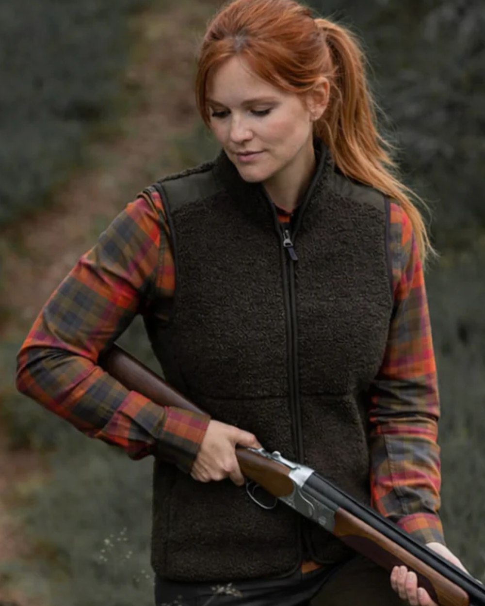 Dark Green coloured Northern Hunting Womens Gunni Fleece Vest on forest background 