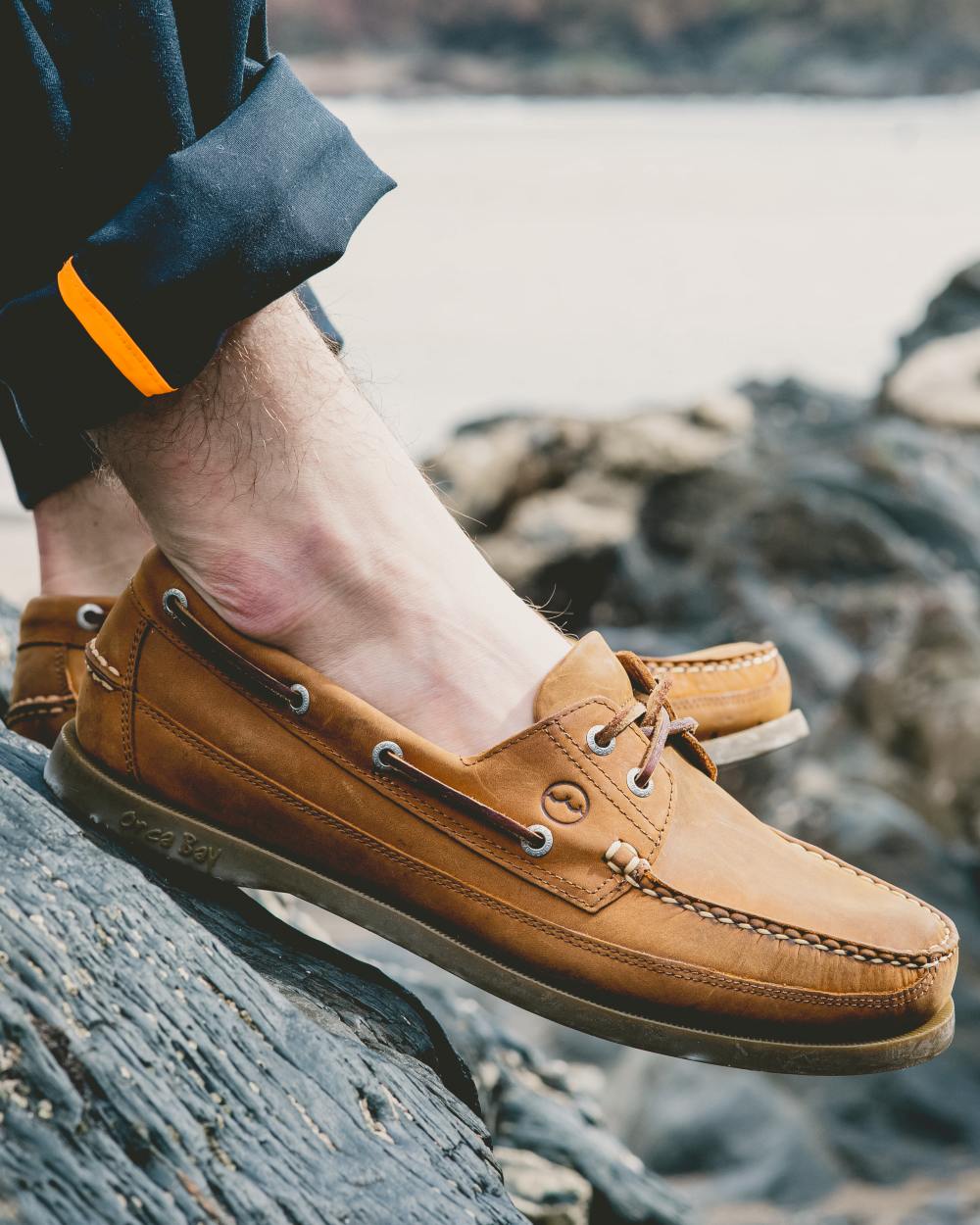 Sand Coloured Orca Bay Augusta Mens Deck Shoes On A Sea Background 