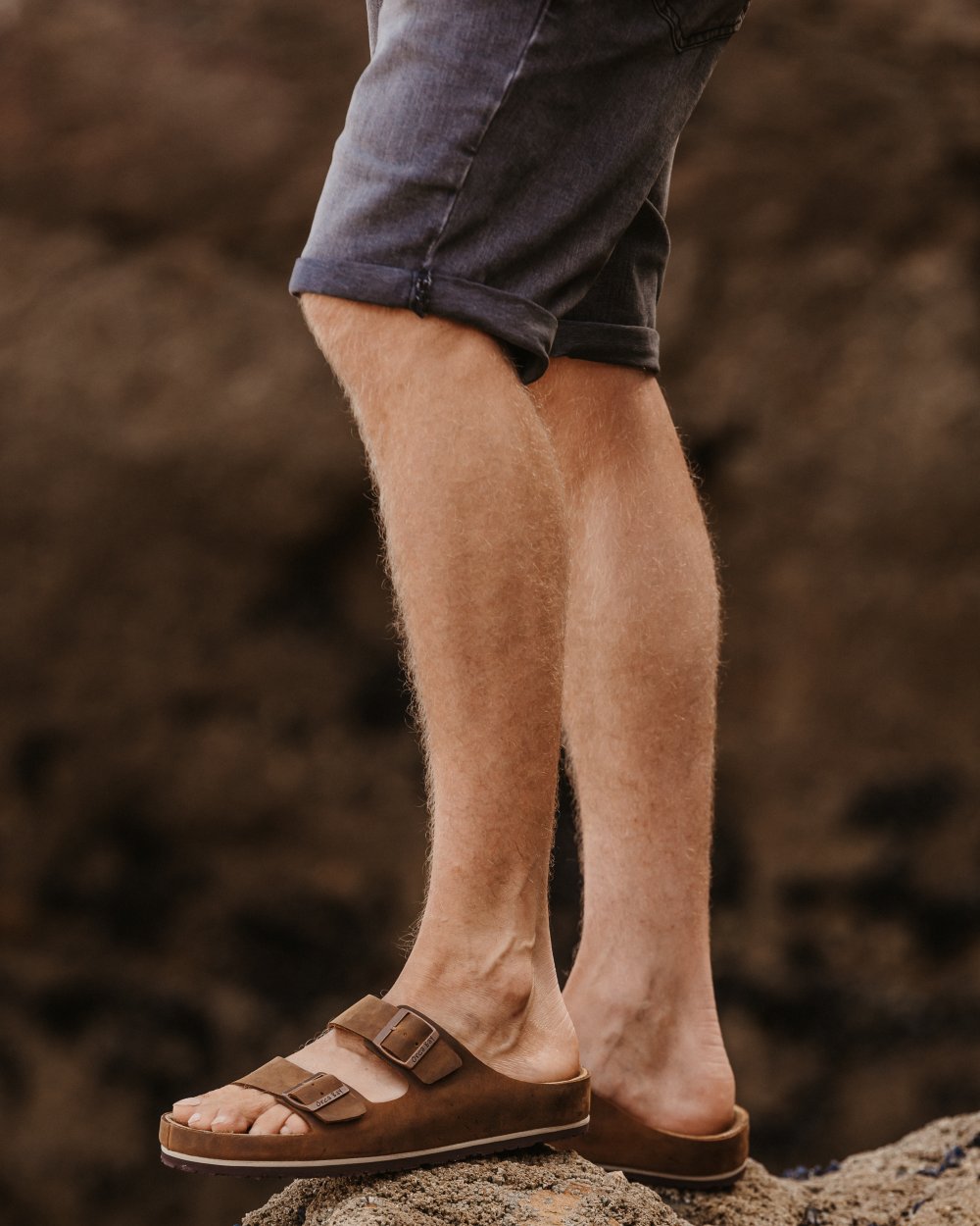 Dark Brown coloured Orca Bay Mens Saba Sandals on stone background 