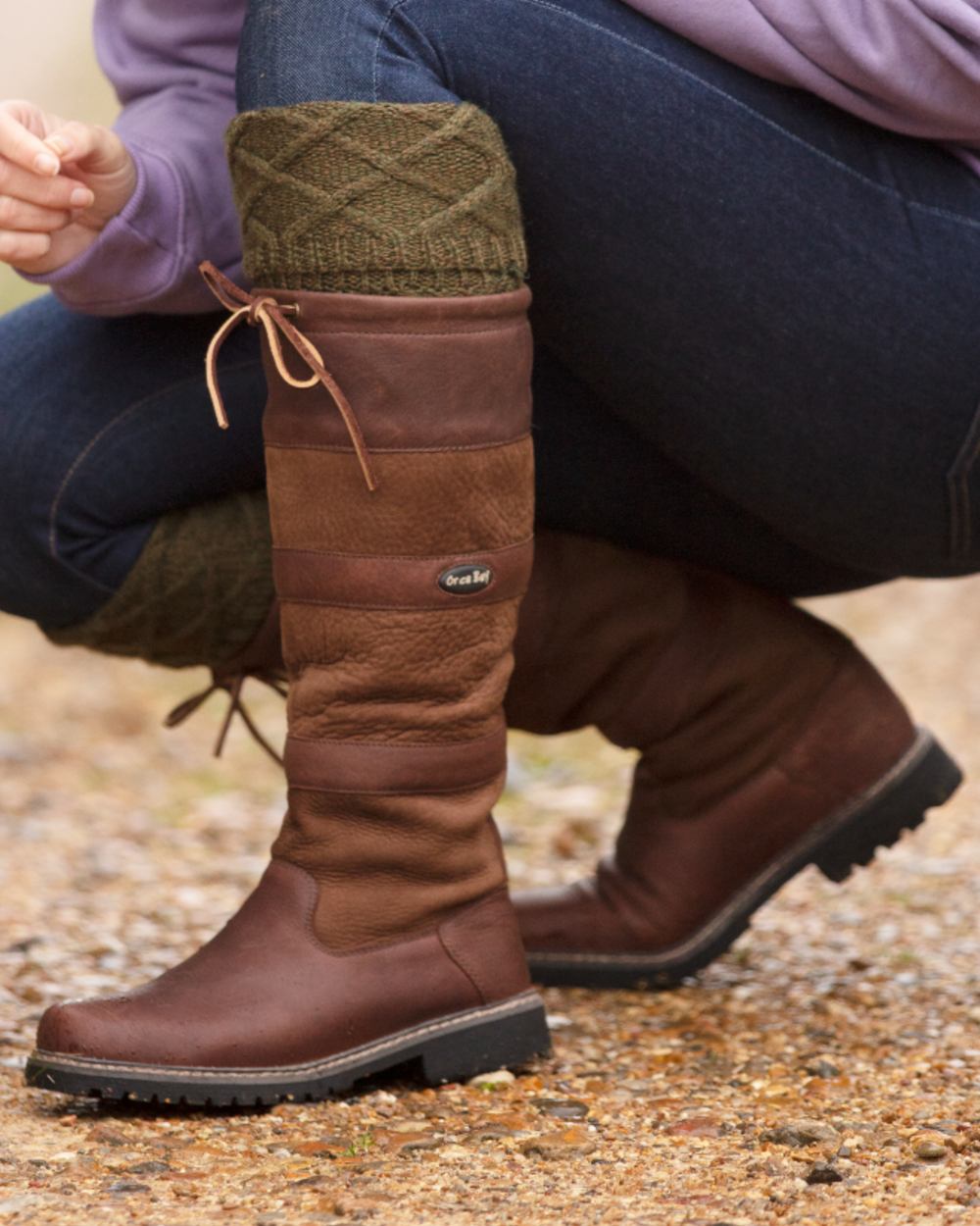 Brown coloured Orca Bay Orkney S-Fit Country Boots on outdoor background 