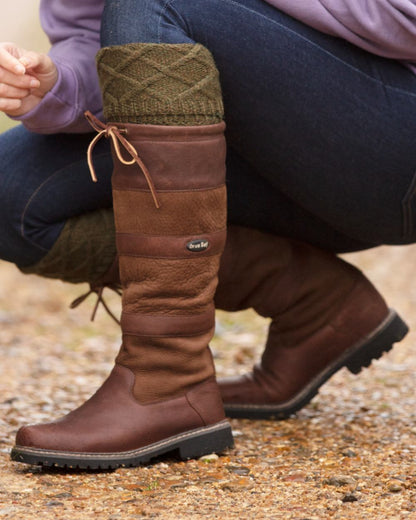 Brown coloured Orca Bay Orkney S-Fit Country Boots on outdoor background 