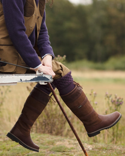 Brown coloured Orca Bay Orkney S-Fit Country Boots on outdoor background 