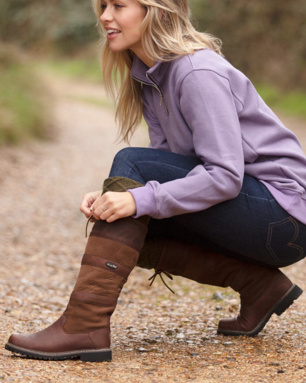 Brown coloured Orca Bay Orkney S-Fit Country Boots on outdoor background 