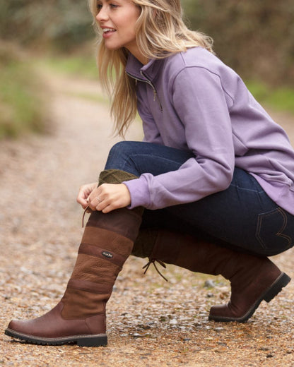 Brown coloured Orca Bay Orkney S-Fit Country Boots on outdoor background 