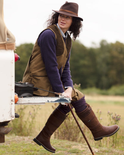 Brown coloured Orca Bay Orkney S-Fit Country Boots on forest background 