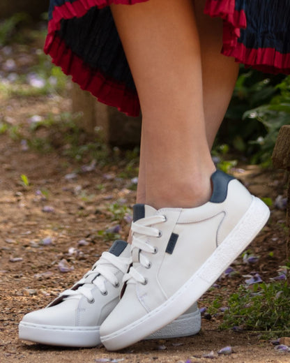 White Navy Coloured Orca Bay Womens Belgravia Trainers on garden background 