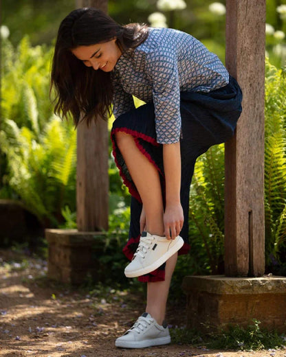 White Navy Coloured Orca Bay Womens Belgravia Trainers on garden background 