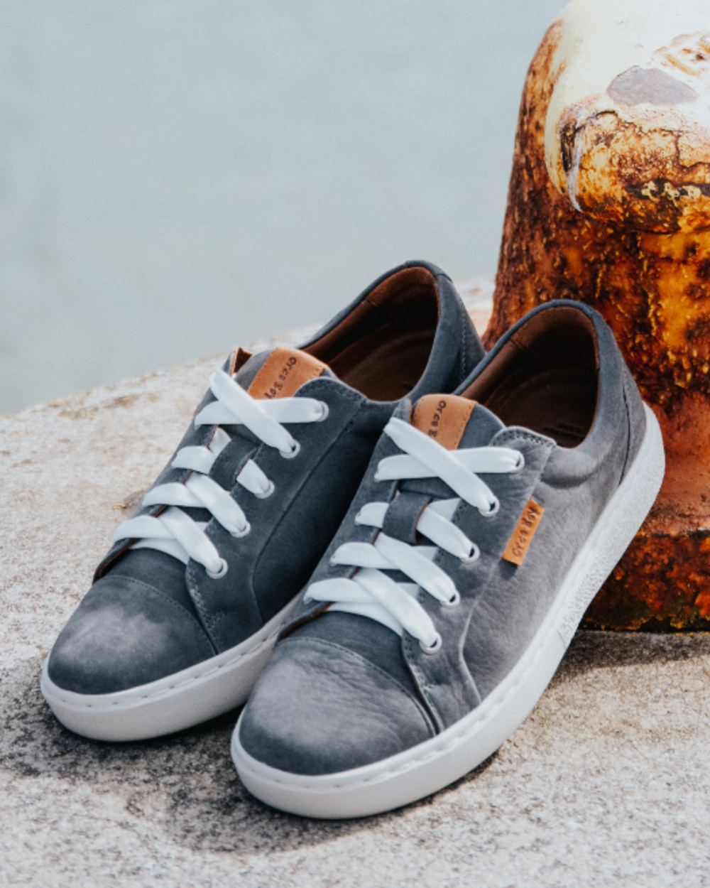 Grey coloured Orca Bay Womens Mayfair Trainers on ocean background 