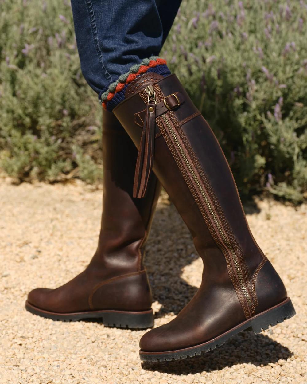 Conker coloured Penelope Chilvers Womens Long Tassel Boots on soil background 
