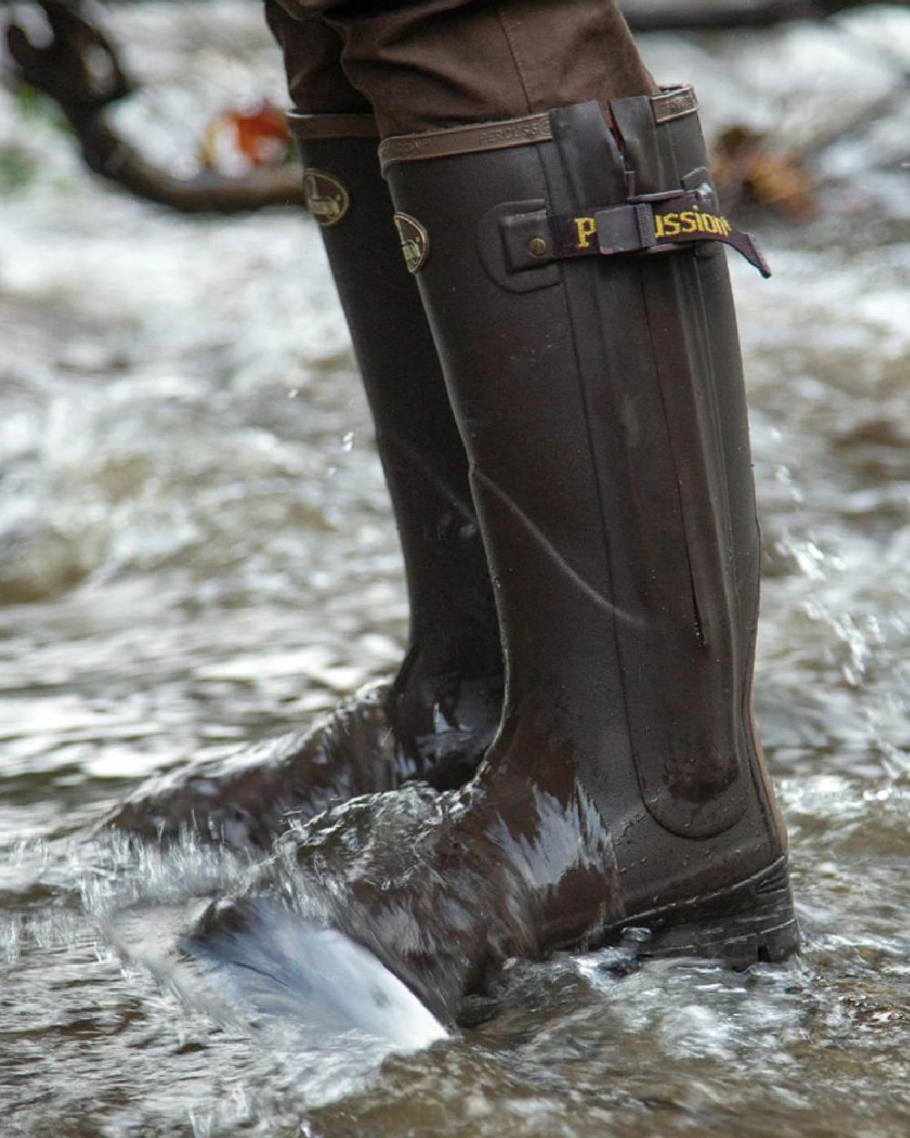 Brown coloured Percussion Rambouillet Full Zip Wellington Boots on water background 