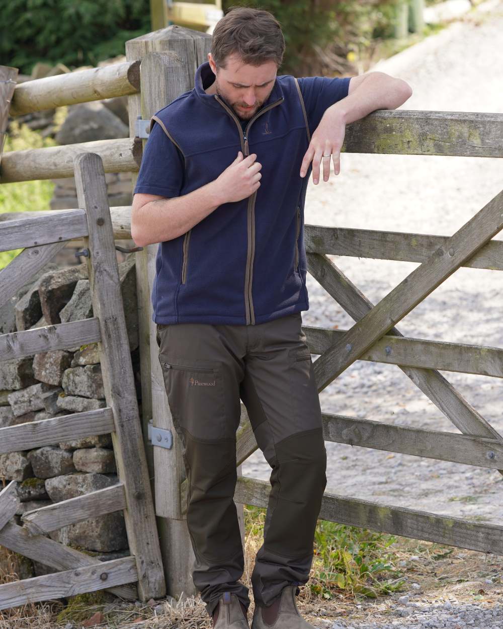 Navy coloured Percussion Scotland Fleece Gilet on farm background 