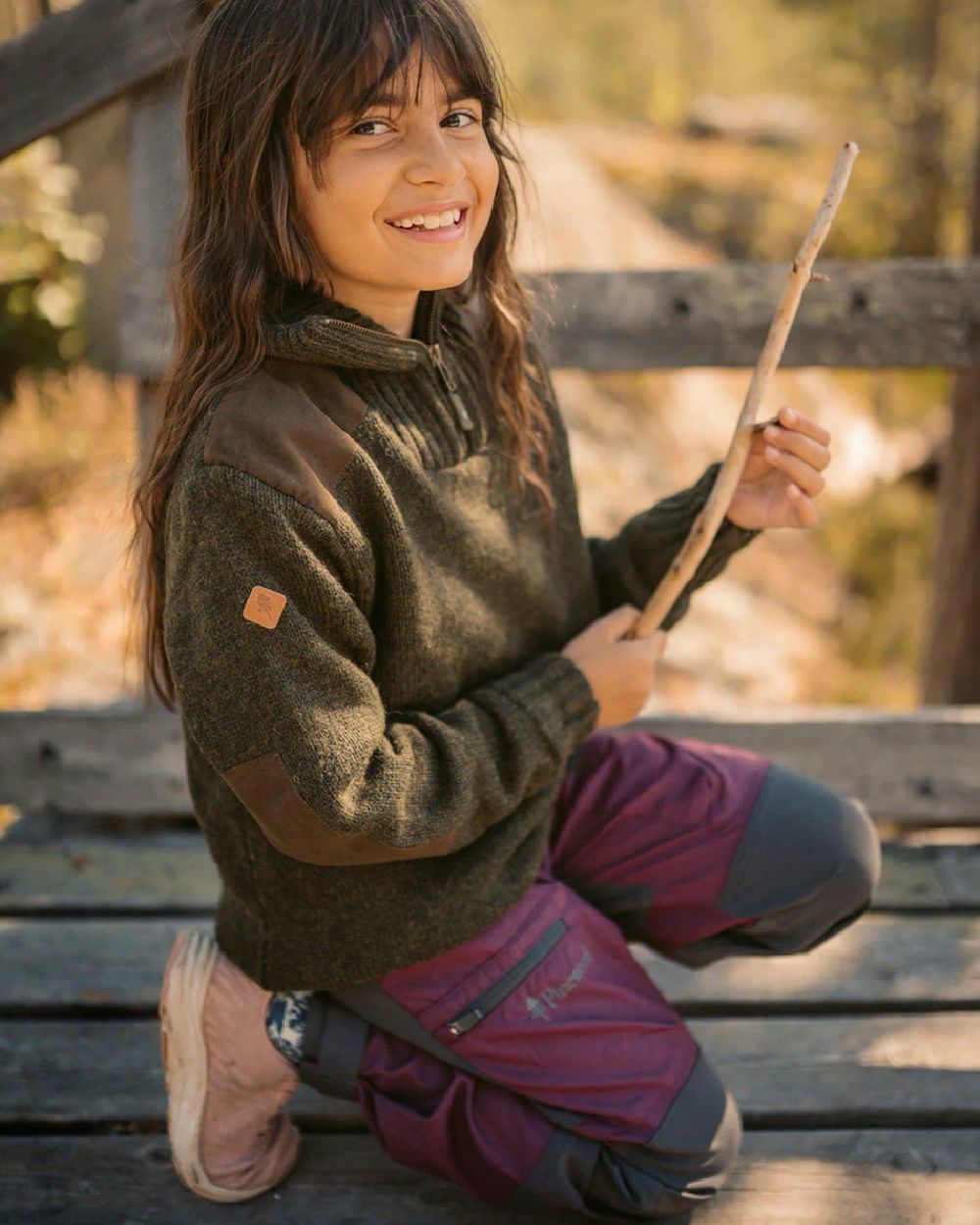 Plum Dark Anthracite coloured Pinewood Childrens Caribou TC Trousers on wooden bench background 