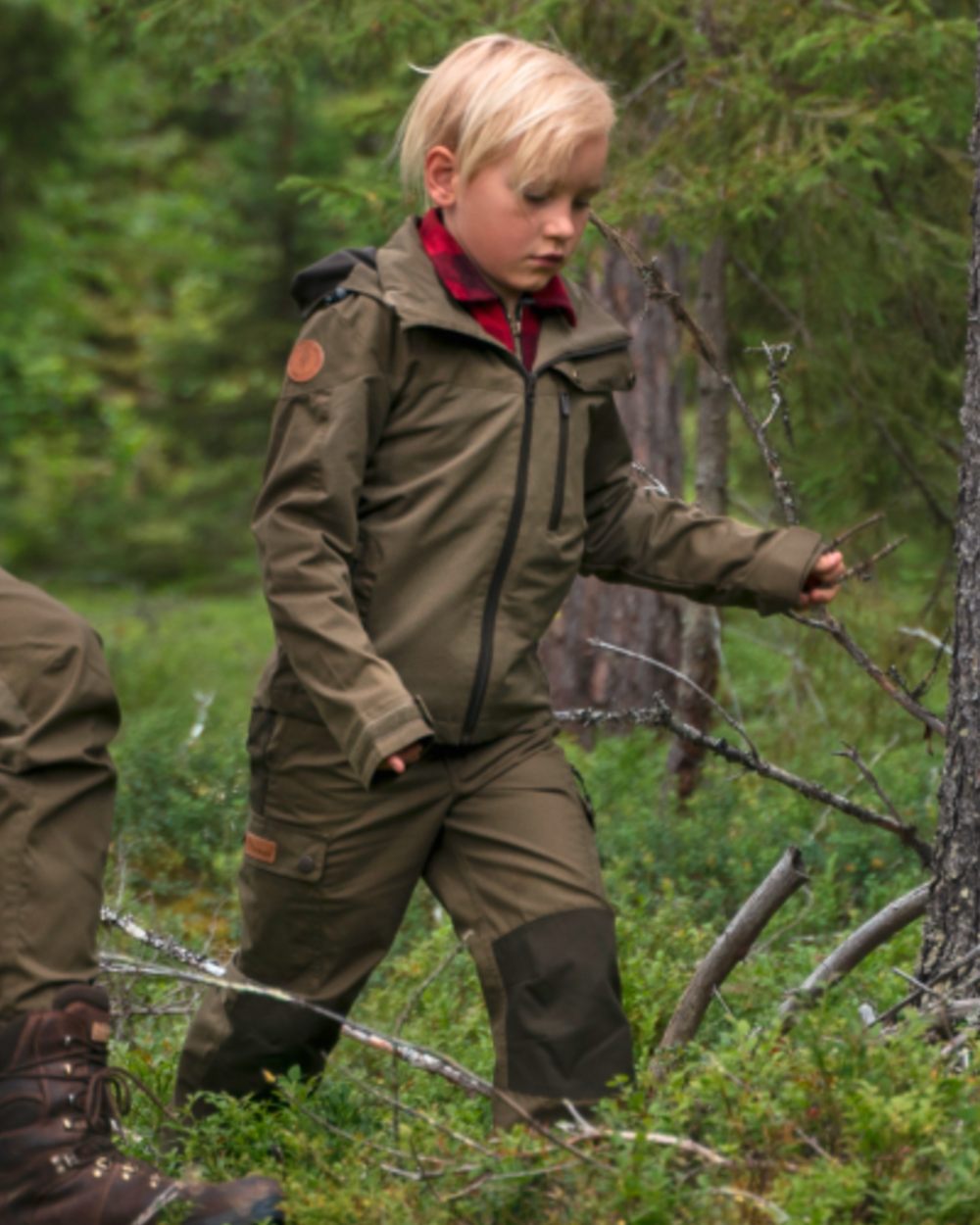 Hunting Olive coloured Pinewood Childrens Finnveden Hybrid Jacket on forest background 