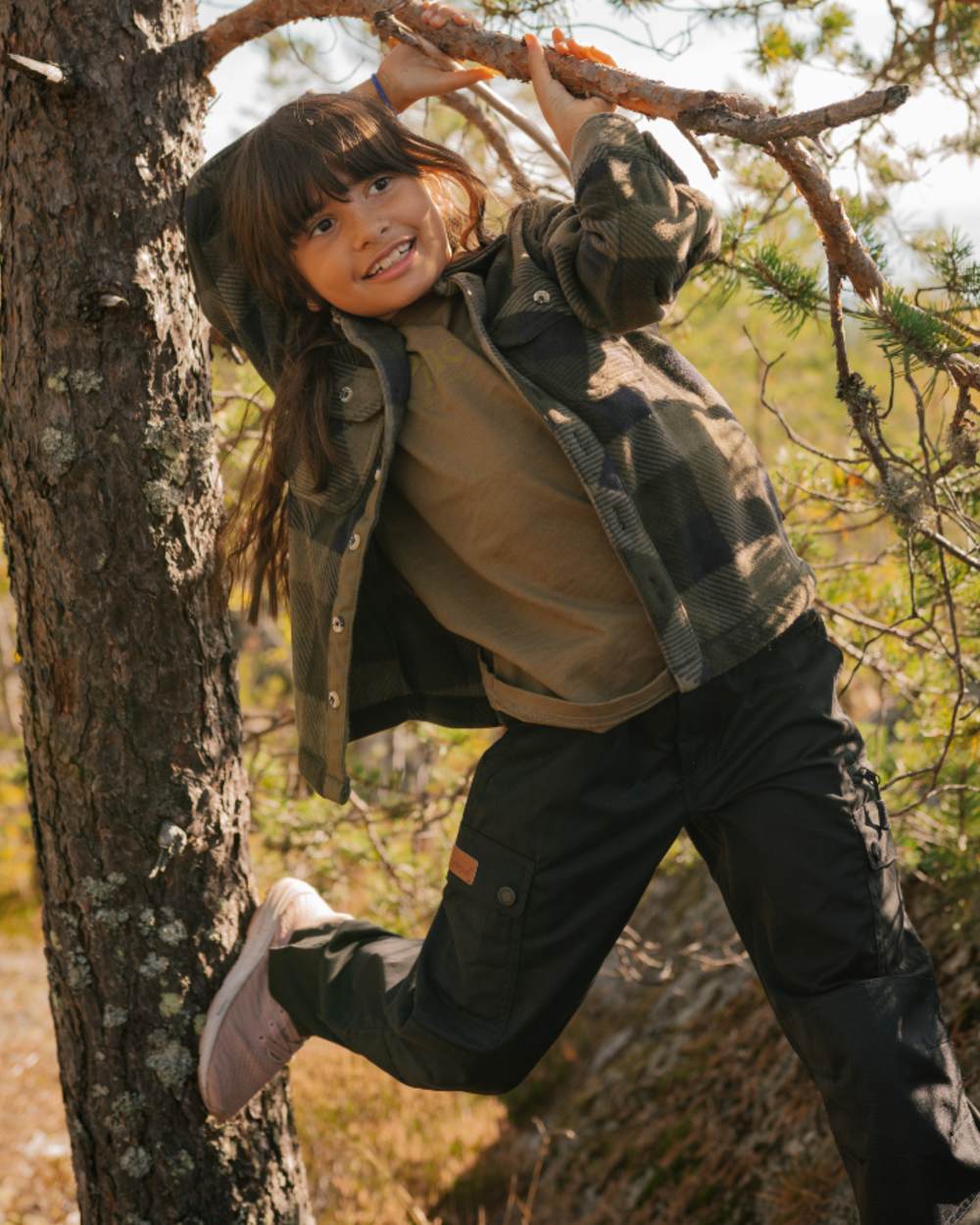 Black coloured Pinewood Childrens Lappland Trousers on forest background 