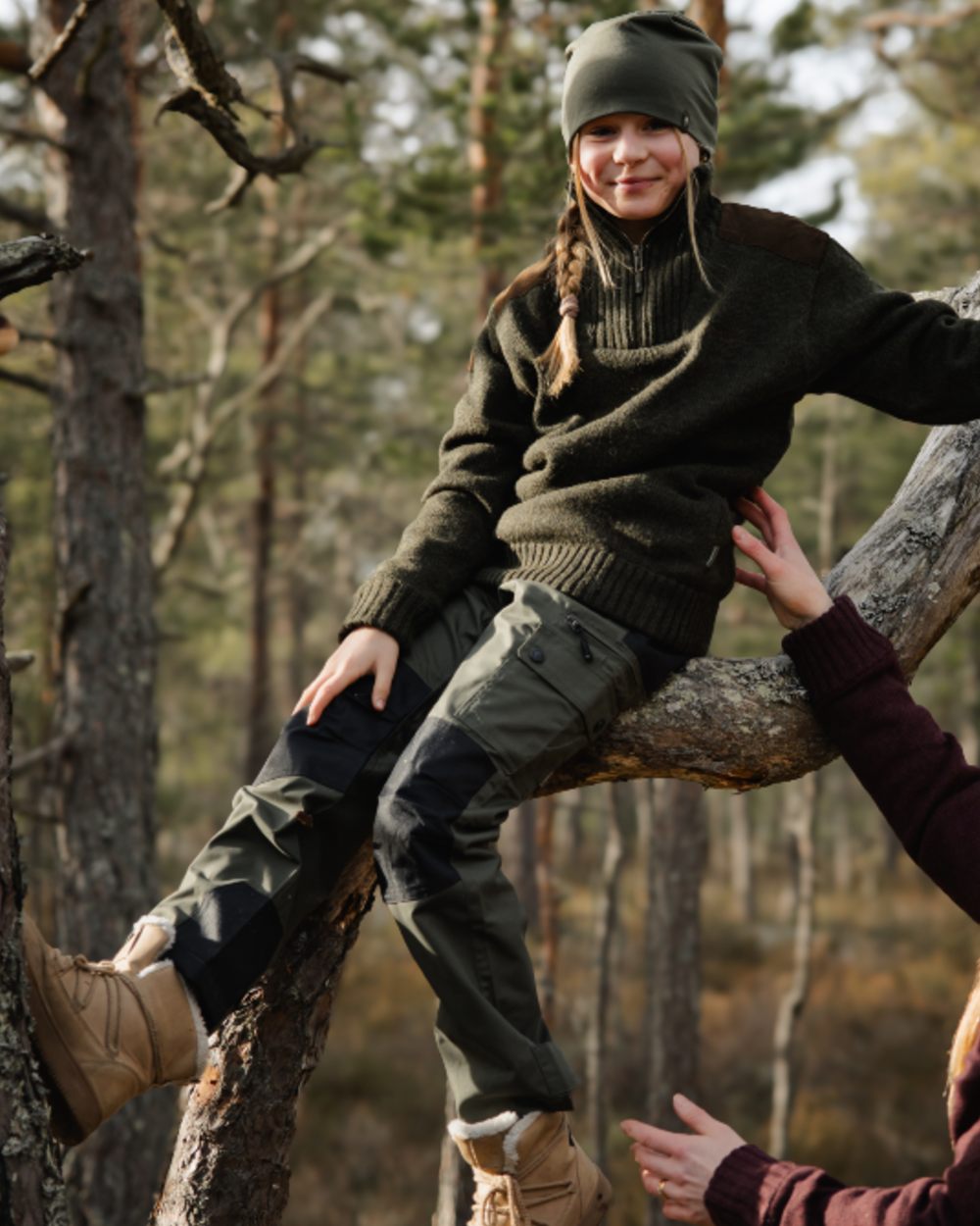 Mid Green Black coloured Pinewood Childrens Lappland Trousers on forest background 