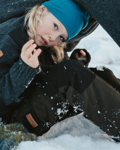 Moss Green Black coloured Pinewood Childrens Lappland Trousers on snow background 