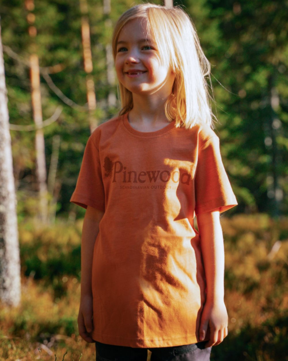 Light Terracotta coloured Pinewood Childrens Outdoor Life T-Shirt on forest background 