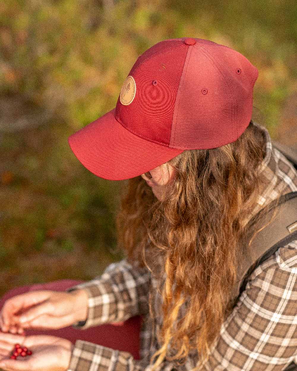 Dark Tomato Dark Red Coloured Pinewood Finnveden Hybrid Cap on outdoor background 