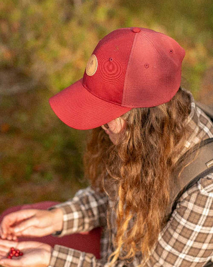 Dark Tomato Dark Red Coloured Pinewood Finnveden Hybrid Cap on outdoor background 