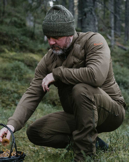 Green Mel Coloured Pinewood Knitted Melange Hat on outdoor background 