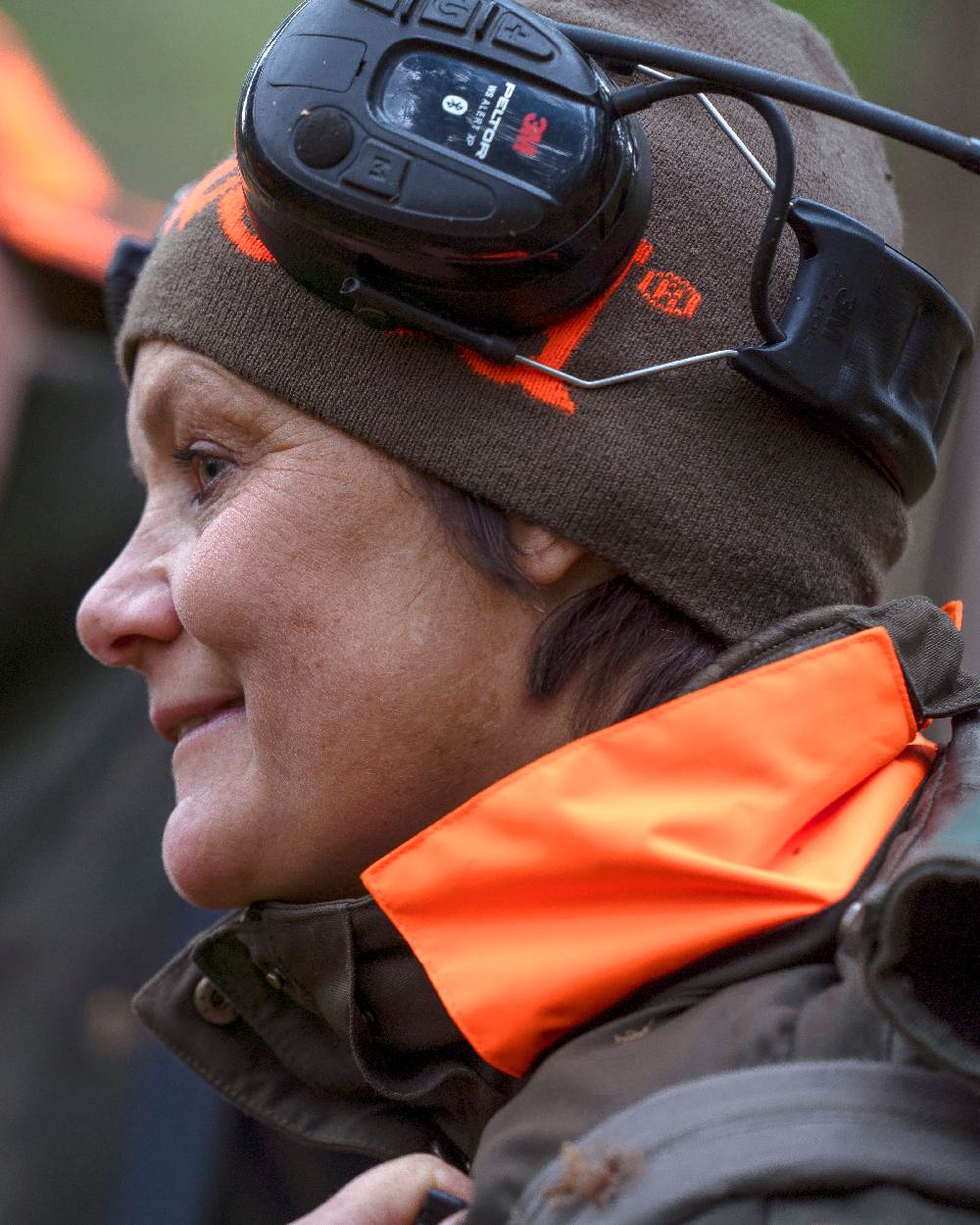 Green Orange Coloured Pinewood Melange Hat on outdoor background 